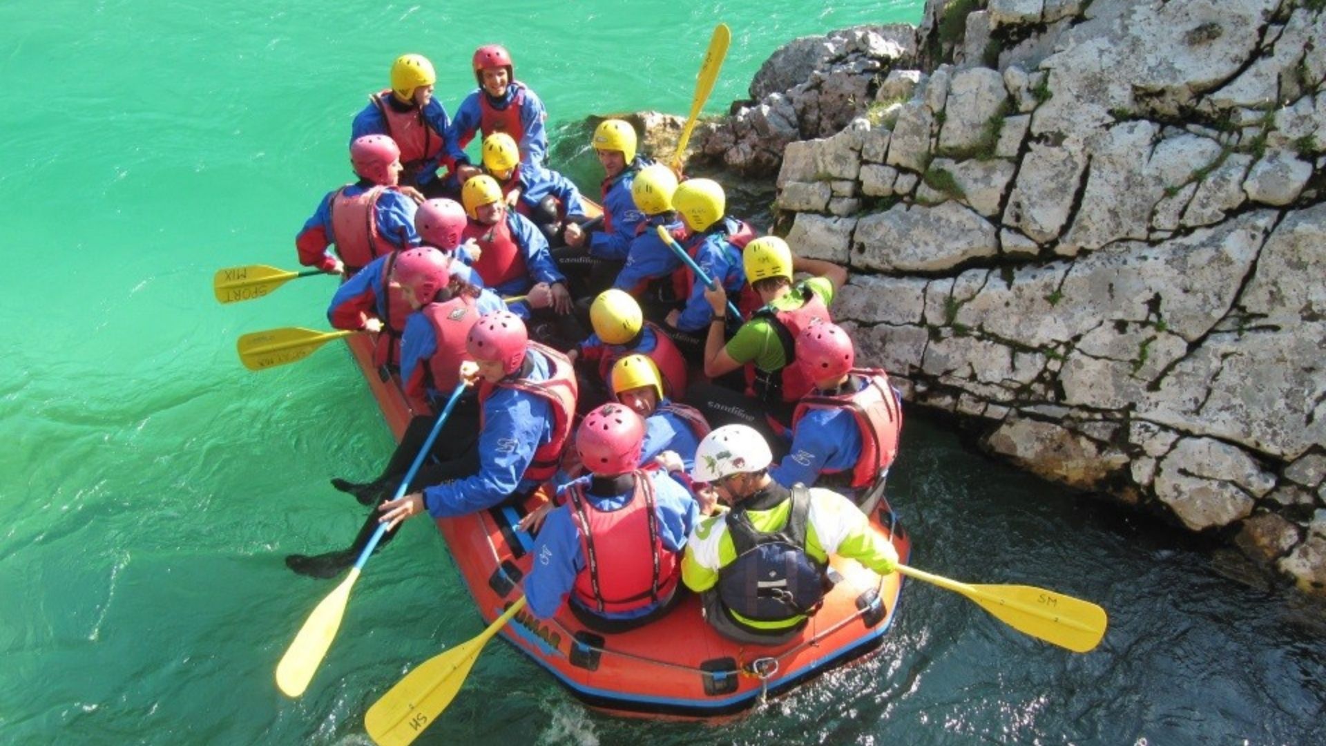 team building participants in a raft
